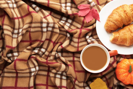 Hot coffee and autumn leaves on plaid - seasonal relax concept. Top viewの写真素材