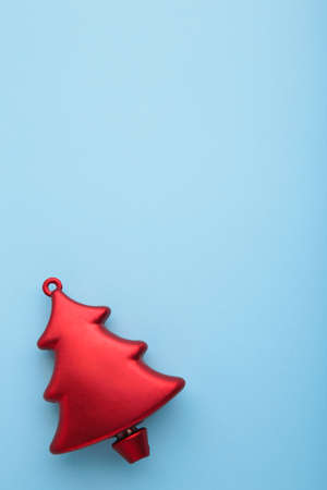 Christmas toy pine tree on blue background. Vertical photo. Top viewの写真素材