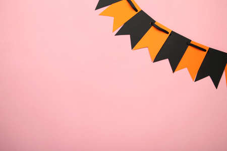 Blank and orange party flags for Halloween decoration on pink background. Top viewの写真素材