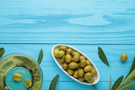 Olive oil with olive on blue background. Top viewの写真素材