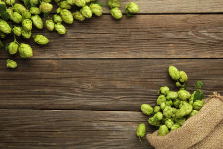Hop in a burlap bag on gray wooden background. Top viewの写真素材