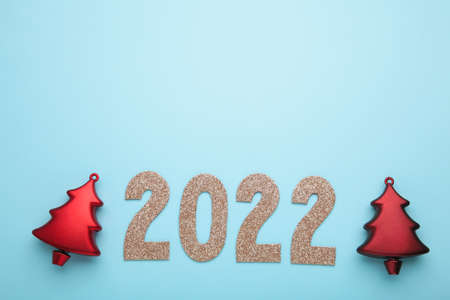 Happy New Years 2022. Christmas background with christmas tree and numerals 2022 on blue background....