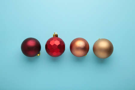 Red Christmas baubles decoration on blue background with copy space. New Year greeting card. Minimal style. Flat lay. Top viewの写真素材