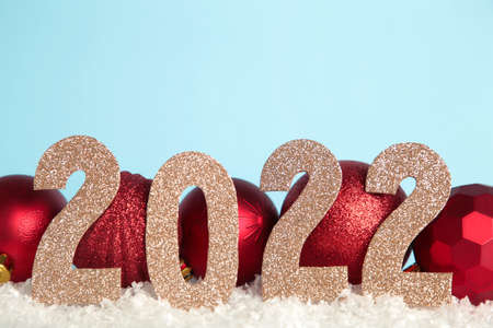 Christmas background with Christmas balls and numerals 2022. New Year concept on blue. Top viewの写真素材