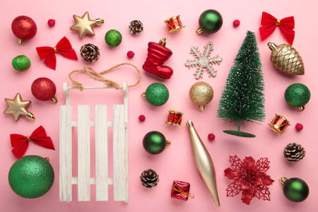 Gold and red Christmas decoration on pink background, top view, flat lay. New Year compositionの写真素材