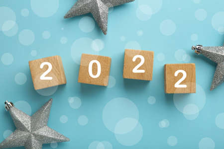 Inscription 2022 with silver snowflakes on blue background. Top viewの写真素材