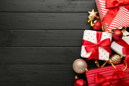 Christmas background with decorations and gift boxes on black background. Top viewの写真素材