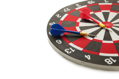 Dart board with blue dart isolated on white background. Top view.