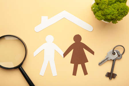 Paper family and house on beige background. Insurance concept. Top viewの写真素材