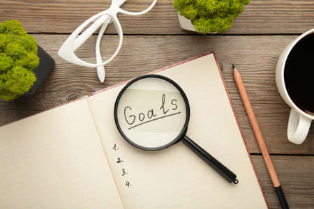 My Goals as memo on notebook with cup of coffee on gray background. Top view.の写真素材