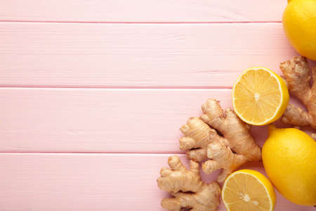 Lemon and ginger on pink background. Top viewの写真素材