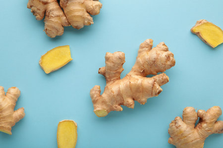 Fresh ginger root on blue background. Vitamins. Top view.の写真素材