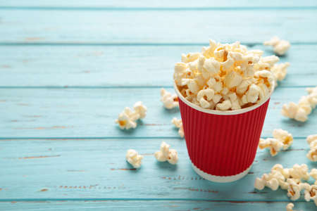 Delicious popcorn on light blue background. Space for text. Top viewの写真素材