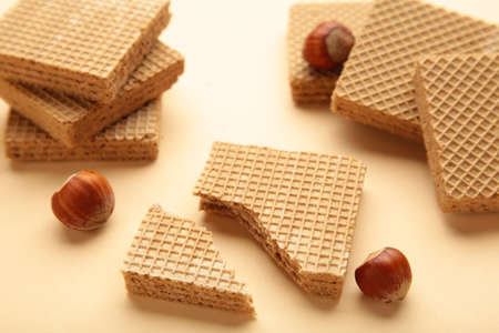 Square chocolate wafer biscuits with hazelnut on beige background. Top view.の写真素材