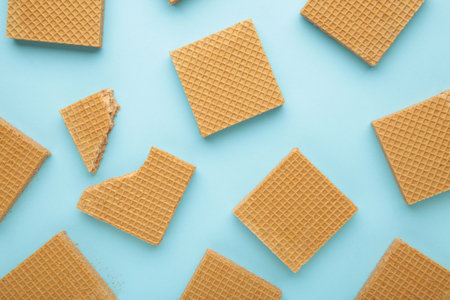 Square chocolate wafer biscuits on blue background. Top view.の写真素材