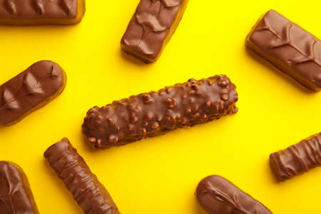Mix of chocolate bars on yellow background.の写真素材