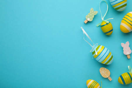 Easter eggs with decoration on blue background with copy space. Top viewの写真素材