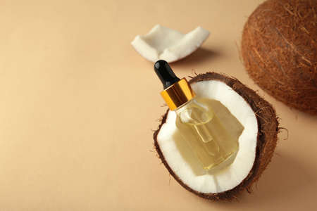 Coconut oil with coconut on beige background.の写真素材