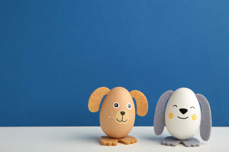 Easter holiday concept with cute handmade eggs, dogs on blue background. top viewの写真素材