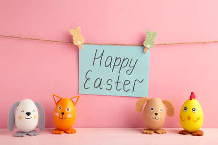 Inscription Easter on rope with clothespins and eggs. The concept of postcards for the Easter...