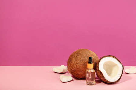 Coconut oil with coconut on pink background.の写真素材