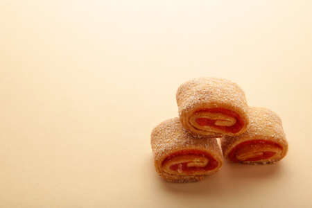 Homemade cookies, mini rolls with apricot jam on beige background. top view.の写真素材