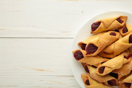 Tasty bagels with strawberry jam on white wooden background. top viewの写真素材