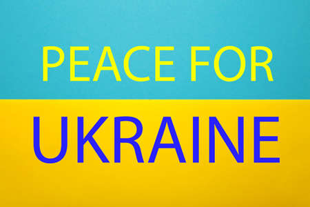 Peace in Ukraine in War after Attack from Russia. Inscription peace on a yellow-blue background in the colors of the Ukrainian national flag. Top viewの写真素材