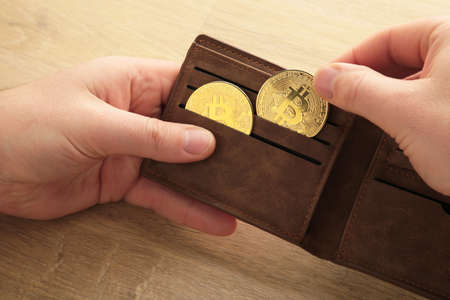 businessman holding bitcoin. Golden bitcoin coins in man hands. virtual currency. cryptocurrencies....