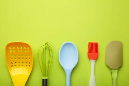 different kitchenware on a green background top view. cooking appliances.の写真素材