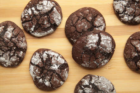Soft dark chocolate brownie cookies on light background. top view