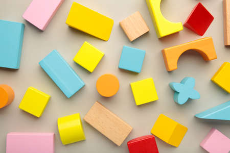 Multicolored blocks of the children's constructor lie on gray background. top viewの写真素材