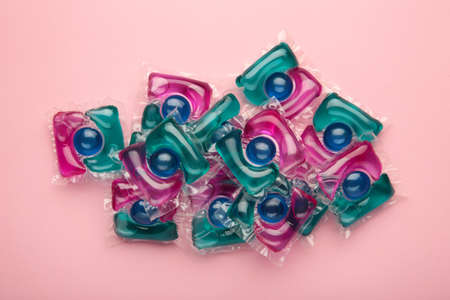Laundry capsule detergent pods for washing clothes on pink background. top viewの写真素材