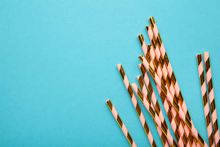 Drinking paper colorful straws for summer cocktails on light blue background with copy space. top view.の写真素材