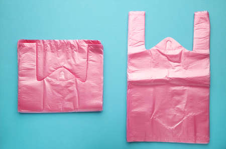 Punk plastic bags on blue background. top view.