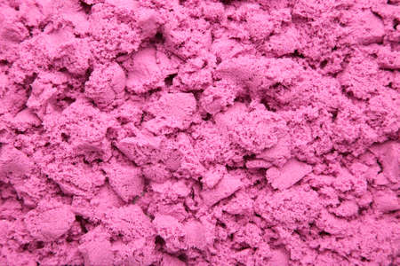 Background pink kinetic sand for children with copy space. Magic sand for children's creativity