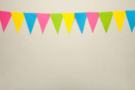 Hanging party flags on white background, decorate items for festival, celebrate event. top viewの写真素材