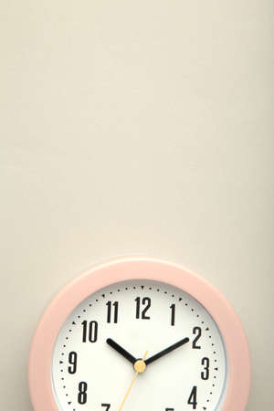 Pink clock on gray background. top view. Macro