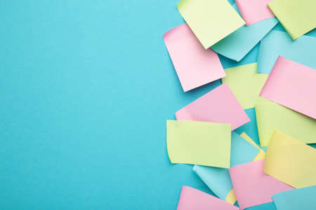 Colorful sticky notes on blue background. top viewの写真素材
