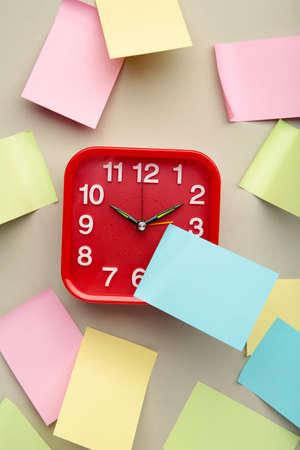 Alarm clock and stickers with space for text on gray background. top view. vertical photoの写真素材