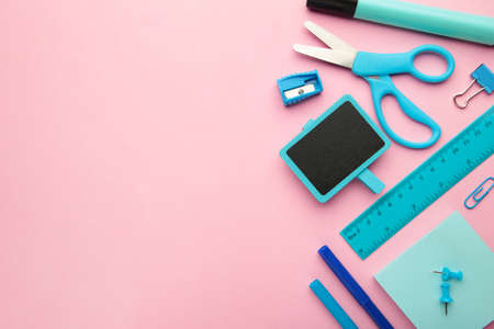 Different stationery on pink background, flat lay with space for text.