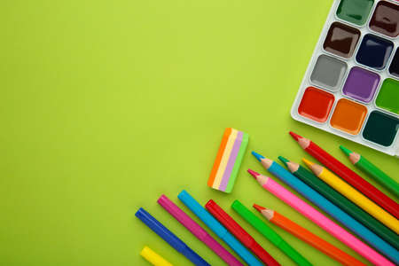 Different stationery on green background, flat lay with space for text.の写真素材