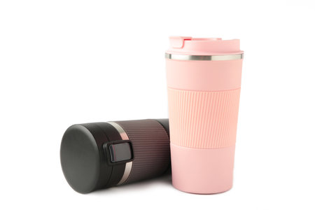 Two thermo cups or  mugs for tea or coffee isolated on white background. Black and pink for him and her. Hot drinks for couples. top viewの写真素材