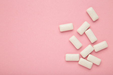 Chewing gum pieces on pink background. Space for text. top viewの写真素材