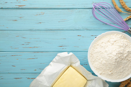 Ingredients for baking or cooking, flour, butter on blue wooden background. Cookie pie or cake...