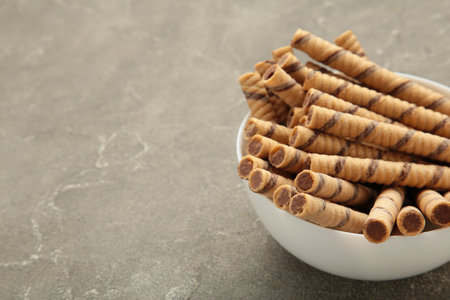 Coffee wafer stick roll with coffee cream on gray background. Space for textの写真素材