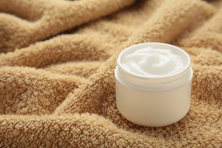 Jar with face cream beauty cosmetic product on towel. Space for text. top viewの写真素材