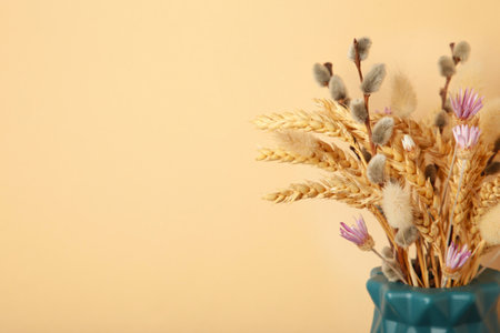 Dry flower in a vase on beige background. top viewの写真素材