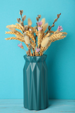 Dry flower in a vase on blue background. top viewの写真素材