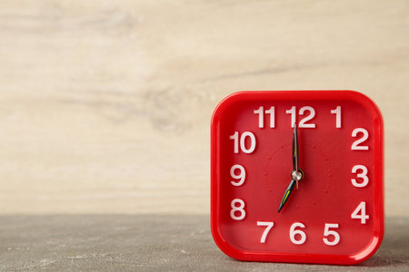 Good morning concept - modern alarm clock and houseplant on light background. top viewの写真素材
